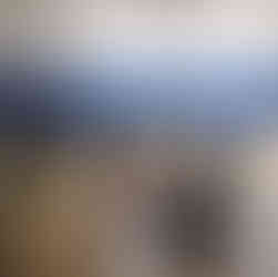 Group of kids sitting on yoga mats in a gymnasium meditating for wellness.