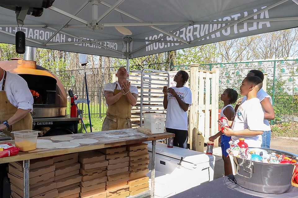 Chef tosses pizza dough; 