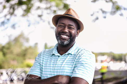 Smiling man wearing hat. Happy man in a striped shirt outdoors