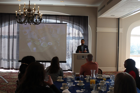 Man presenting at podium with projection screen; CEO Transition; BGCCA