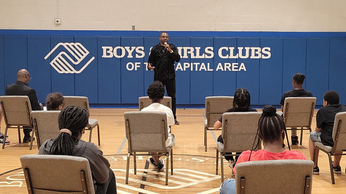 Man speaking to youth Boys & Girls Clubs of the Capital Area BGCCA.