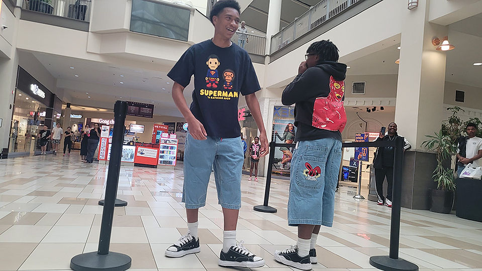 Young men wearing Superman shirts in the mall with denim shorts BGCCA