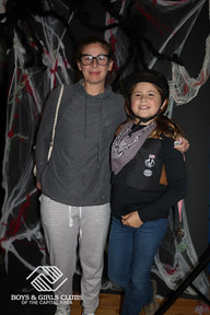 Woman in glasses with girl: Halloween event, background, smiling. BGCCA.