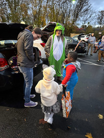 People in costumes, Halloween 2023, trick-or-treating, a fun community event.