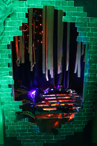 Halloween-themed display with a brick wall, decorations, and a spooky atmosphere Halloween 2023.