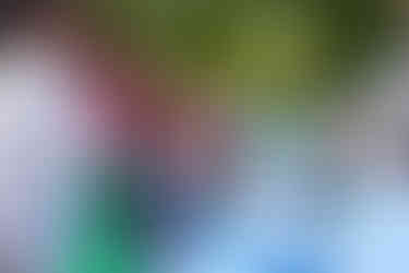 Girl looking at a display with others 2024-25 Kwanzaa BGCCA event with tables.