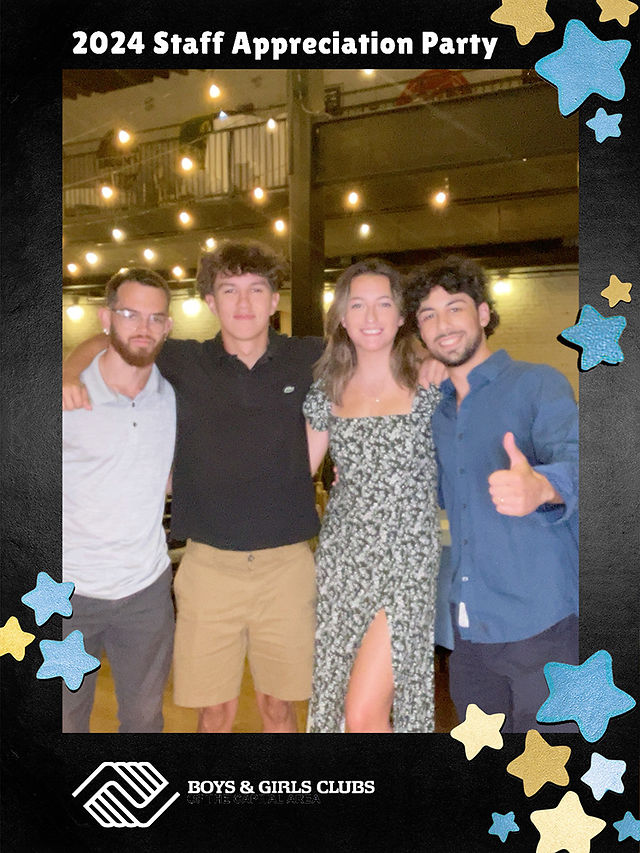 Four friends smiling and posing together, thumbs up with backdrop BGCCA.