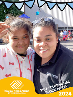 Two smiling women pose outdoors near a building and text, BGCCA.