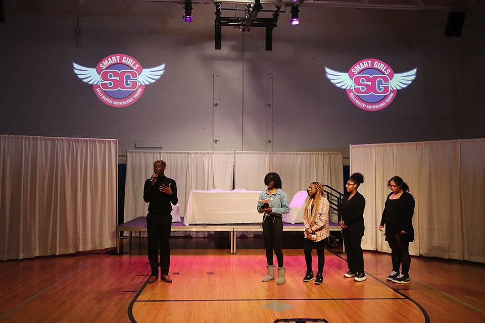 Group of people in front of two Smart Girls logos and BGCCA.