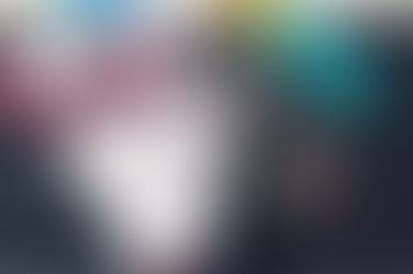 Pile of bookmars on a cutting mat, with scissors, rotary cutters, hole punchers, and thread