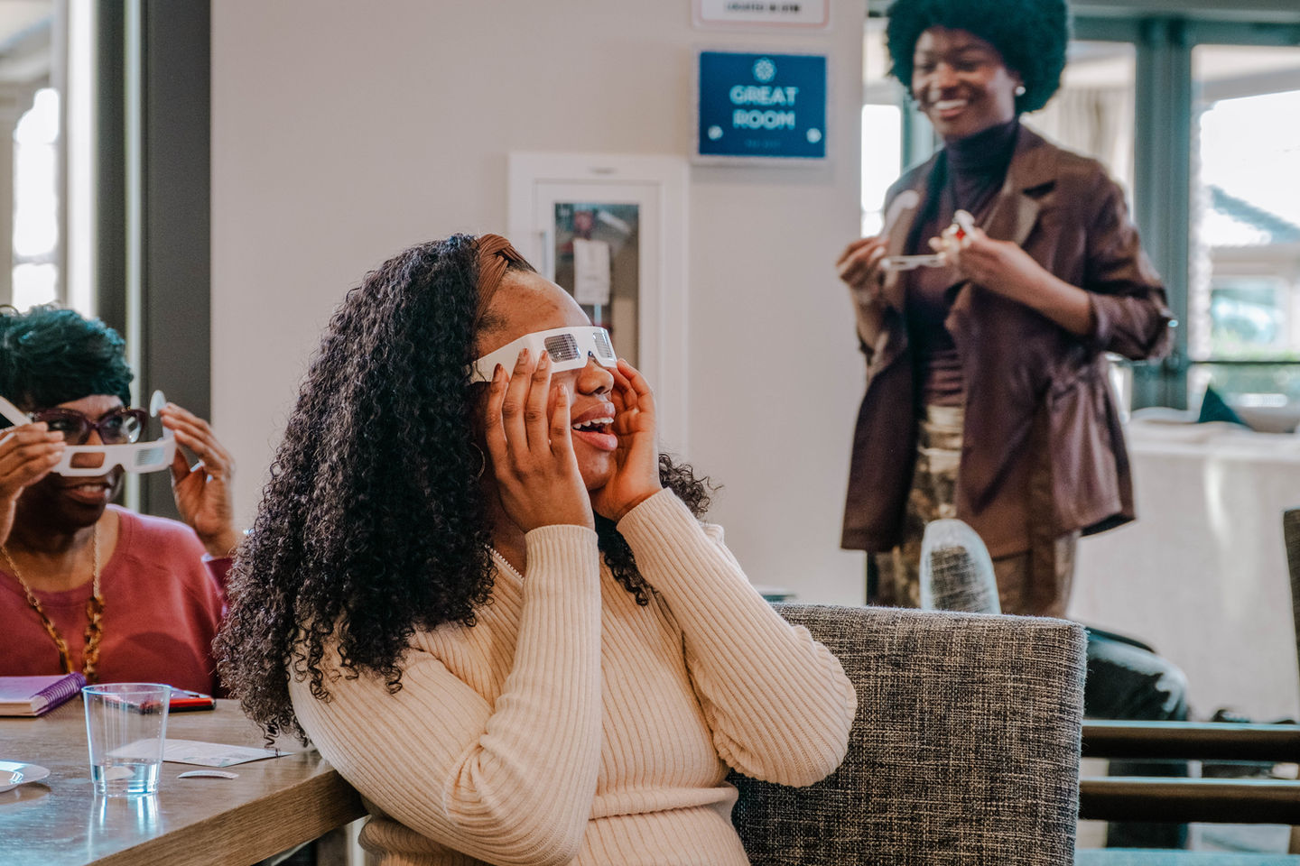 Attendees laughing while wearing 3D glasses in the Great Room at BIRTHCon 2025.