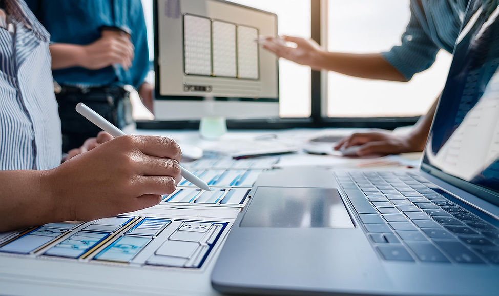 Firefly close up of computer screen and desk where a team of graphic designers are collabo