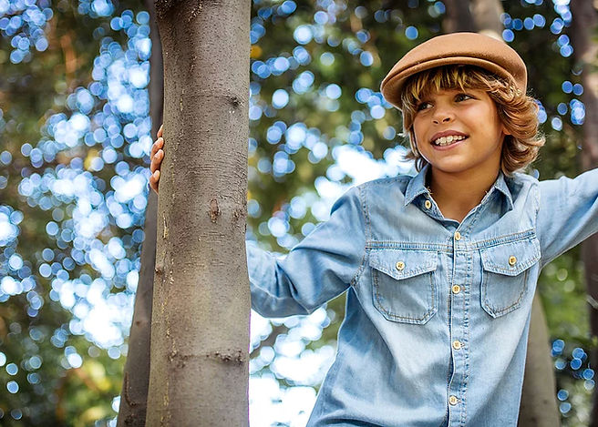Boy smiling playing in tree