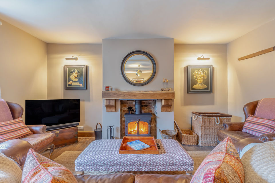 Robin Hood - Lower lounge with log burner, plush leather seating and unique art pieces on the walls