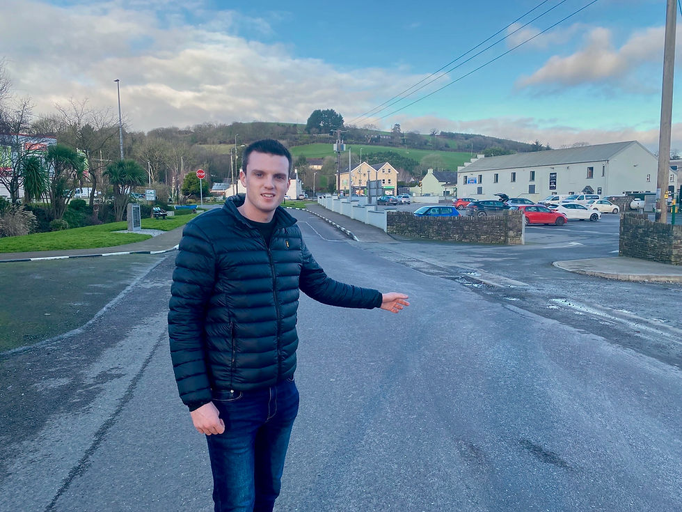 Cllr Ben Dalton-O'Sullivan pointing to the need for a pedestrian crossing between the Marian Halll and Fairy Park,Ballinhassig - photo Leo McMahon