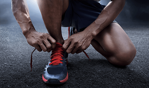 man in trainers ready to run
