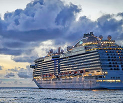 Premium, upscale cruise ship aglow as evening descends.