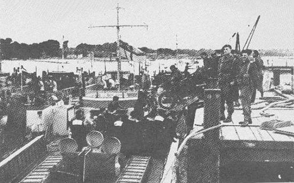 Captain H N Smith RAMC and Marine Bott watching the unit embark.