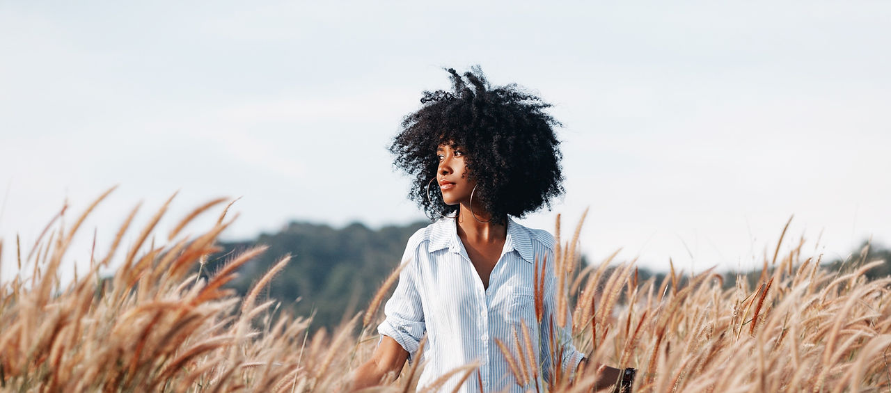 cheerful%2520african%2520american%2520young%2520woman%2520on%2520the%2520field%2520at%2520sunset_edi