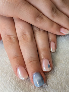 Neutral gel manicure with subtle shimmer and a personalized initial accent nail