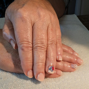 Neutral gel manicure with hand-painted Toronto Blue Jays–inspired accent art on short nails