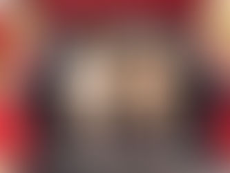 two fluffy Rough Collie dogs sitting on a dog bed in the back of a red car with a open trunk ready for adventure and a car ride