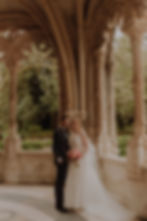 Bride and groom posing in a baroque style pergola