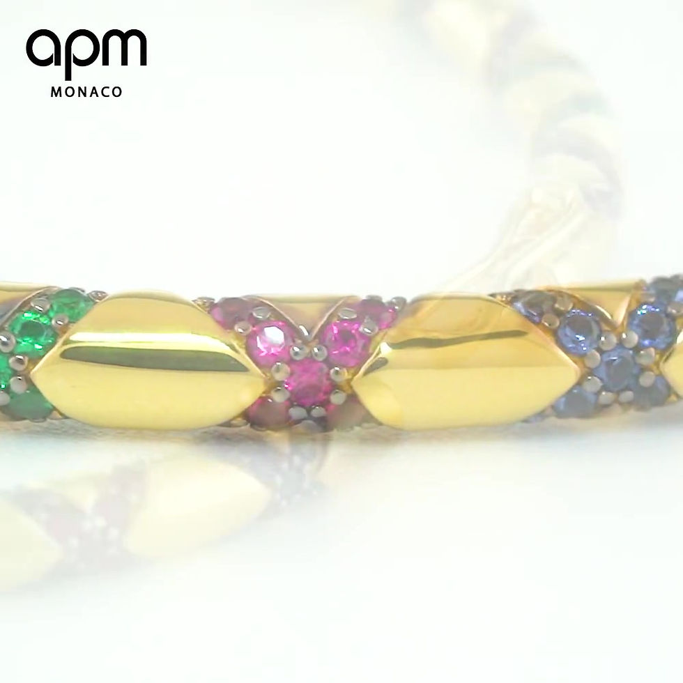 Thumbnail: APM Monaco tribal crossed gold bangle designed by Bastien Carsana, featuring burgundy, green, blue, orange gemstone patterns