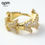 Thumbnail: APM Monaco gold jewelry earrings designed by Bastien Carsana, featuring an arrow motif encrusted with clear stones.