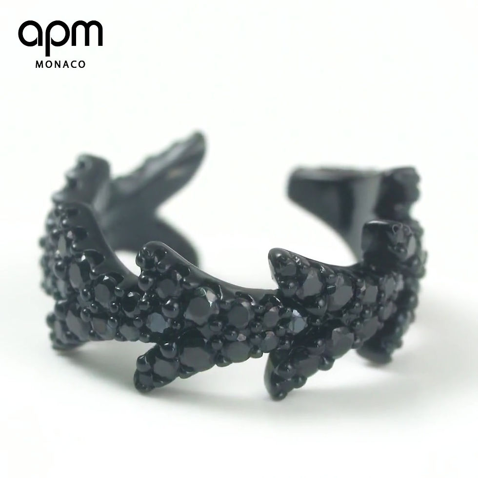 Thumbnail: APM Monaco black jewelry earrings designed by Bastien Carsana, featuring an arrow motif encrusted with dark stones.