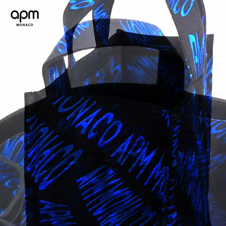 Thumbnail: APM Monaco black oversized canvas tote bag designed by Bastien Carsana with vibrant electric blue embroidery, stylish design.