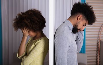 Side View Of Young Unhappy Couple Standing Back To Back At Home.jpg