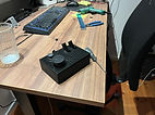 Milantec's first wired prototype of Thumpdrive with a black 3D-printed enclosure on a desk
