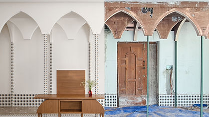 The foyer, dining room, and an open kitchen, delineated by arches and distinct flooring patterns, compose bustling part of th