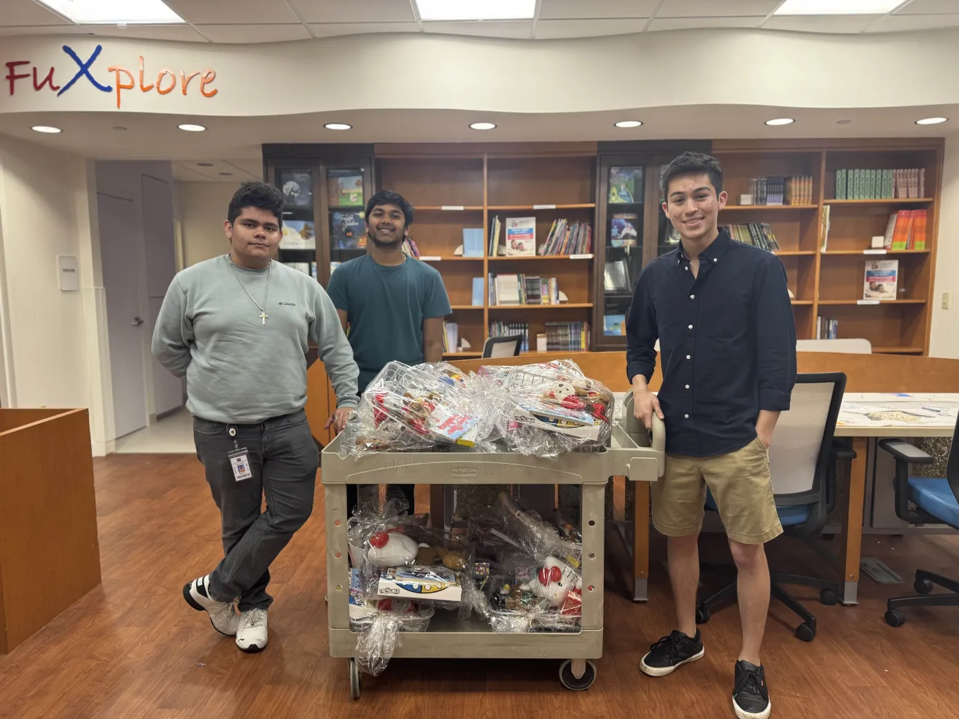 Victor, Camilo, and Yatin posing with the donated baskets from volunteers being dropped off at the children's hospital