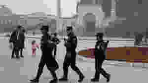 Uighur security personnel patrol near the Id Kah Mosque in Kashgar in western China's Xinjiang region in this 2017 file photo. (Ng Han Guan / Associated Press)