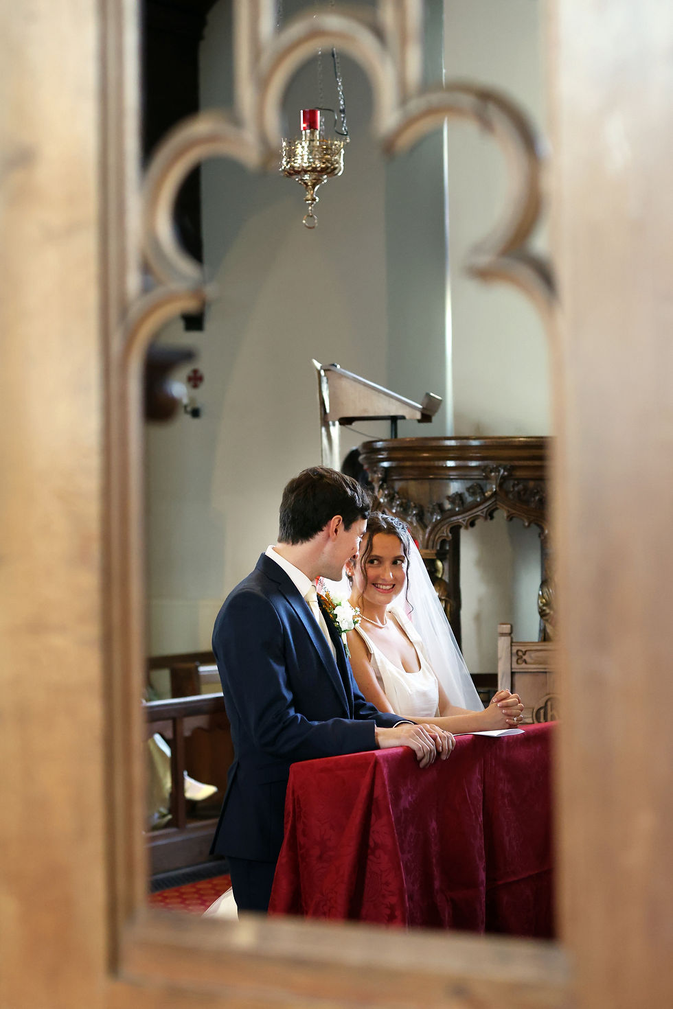 Bride and groom sharing a relaxed moment during their wedding ceremony in Surrey
