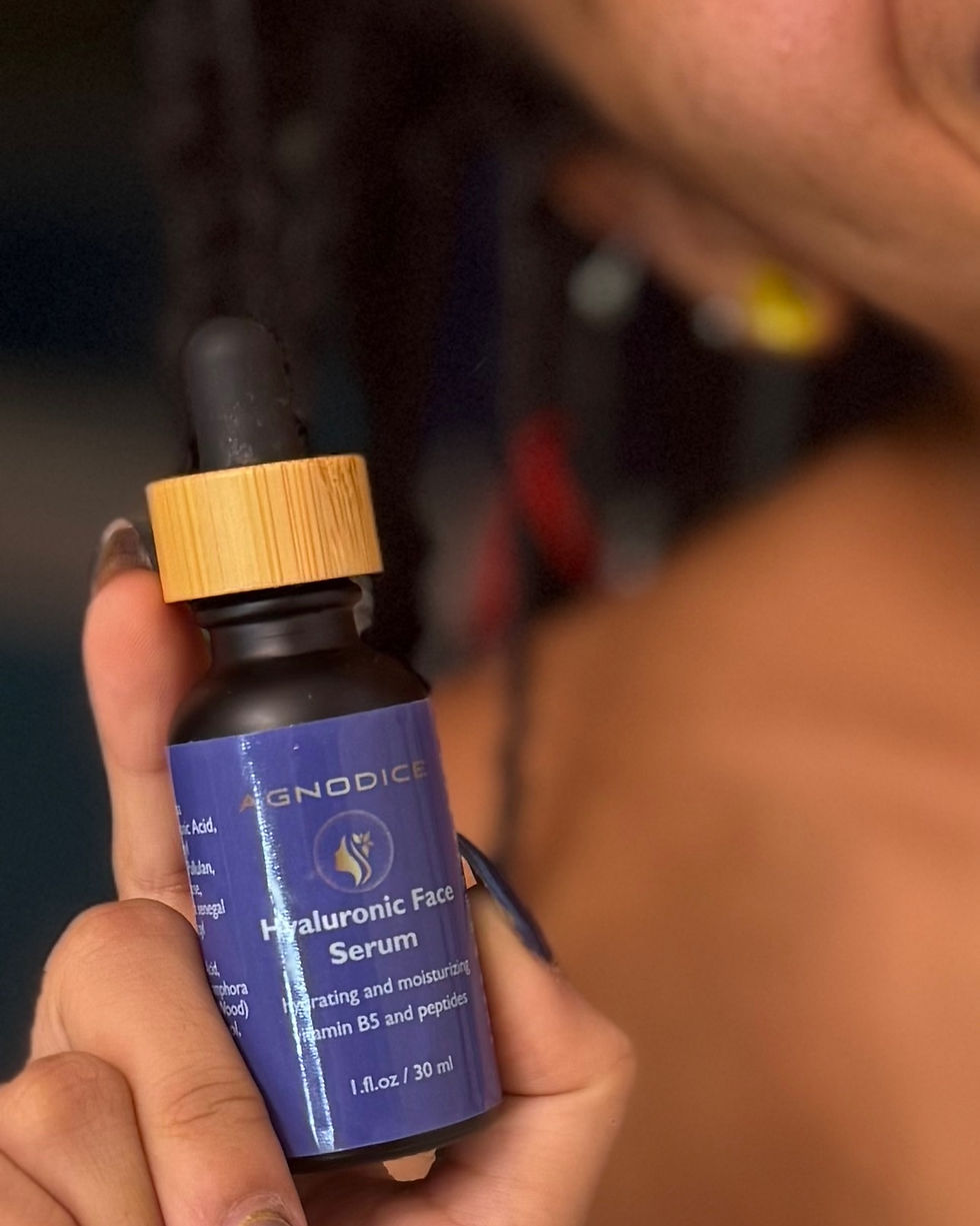 Thumbnail: Hand holding Agnodice hyaluronic face serum glass bottle with vitamin B5 and peptides