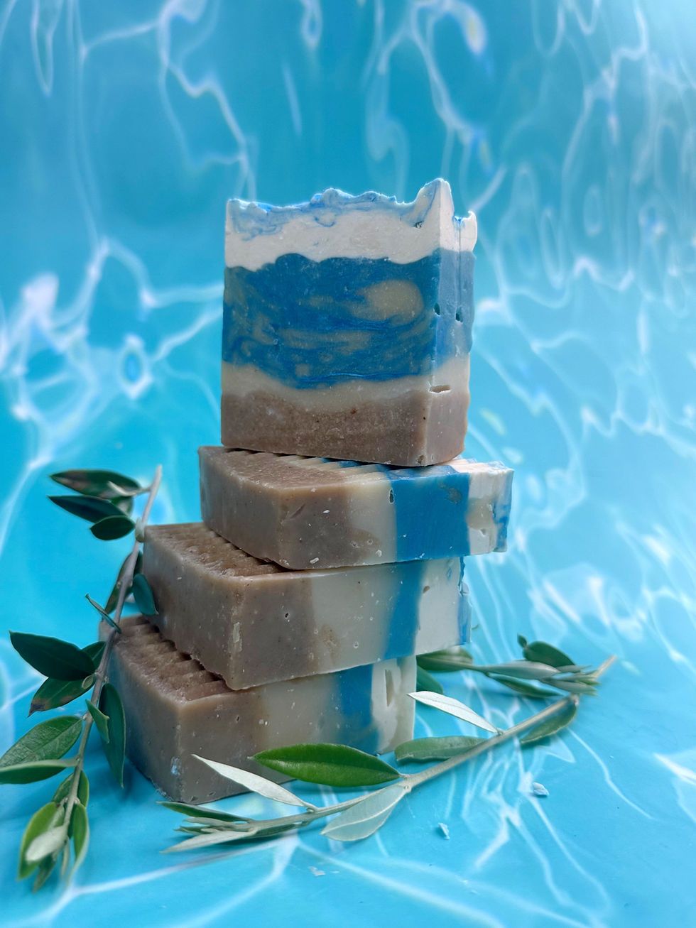 Thumbnail: AGNODICE Stacked Gaia's Tide Dead Sea mud soap bars with olive branches.