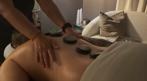 Zi Medspa Massage Therapist giving hot stone massage to client in North Tampa