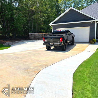 Multi-purpose concrete driveway extension that provides more space to walk into the front door and paves a path to the backyard while also adding more parking space