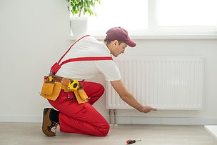 man-work-overalls-using-wrench-while-ins