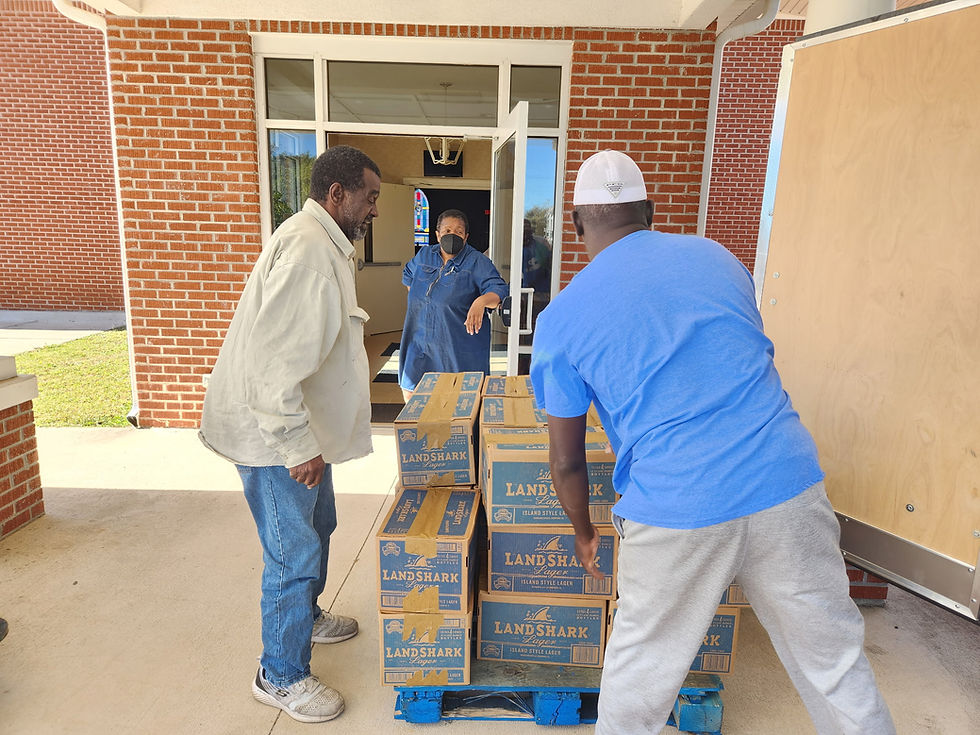Volunteers unloading food donations for the community.