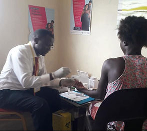 Pastor Billiance Chondwe counseling woman in clinic