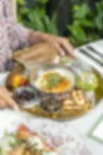 Israeli breakfast plate with organic eggs, avocado, halloumi, olives, and Jerusalem bagels.