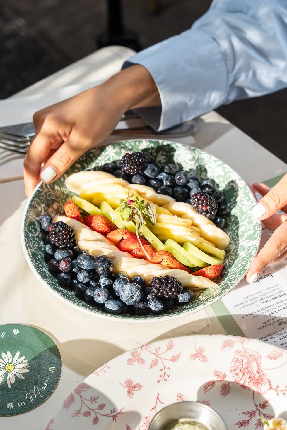 Fresh fruit platter with banana, strawberries, blueberries, and blackberries, served at the best brunch spot in Miami Beach.