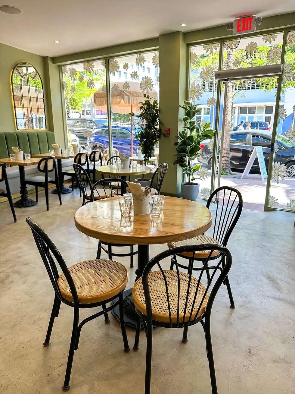 Bright café interior with wooden tables and natural light, perfect for enjoying the best brunch Miami Beach offers.