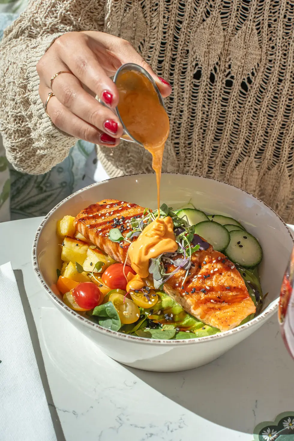 Spicy salmon bowl at a brunch restaurant in Miami Beach with rice, avocado, spicy mayo.