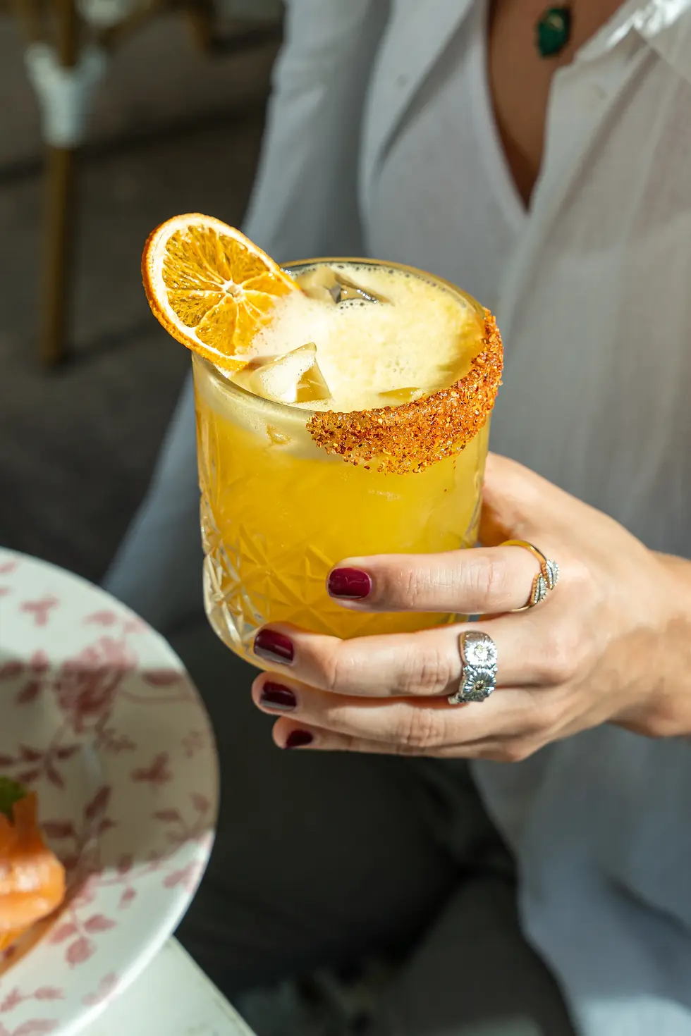 Passion fruit margarita with chili rim and orange slice garnish, a fresh option for brunch with cocktails downtown Miami