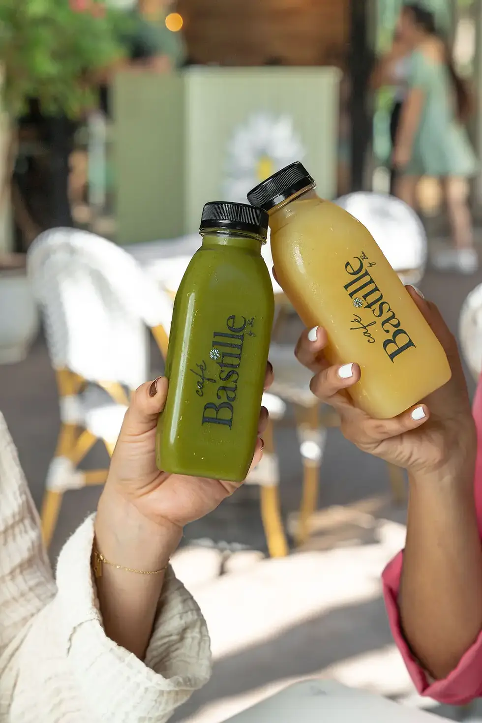 Two cold press juices at Café Bastille: 'Kicker' with kale, celery, pineapple, and ginger, and 'Healer' with apple and lemon.